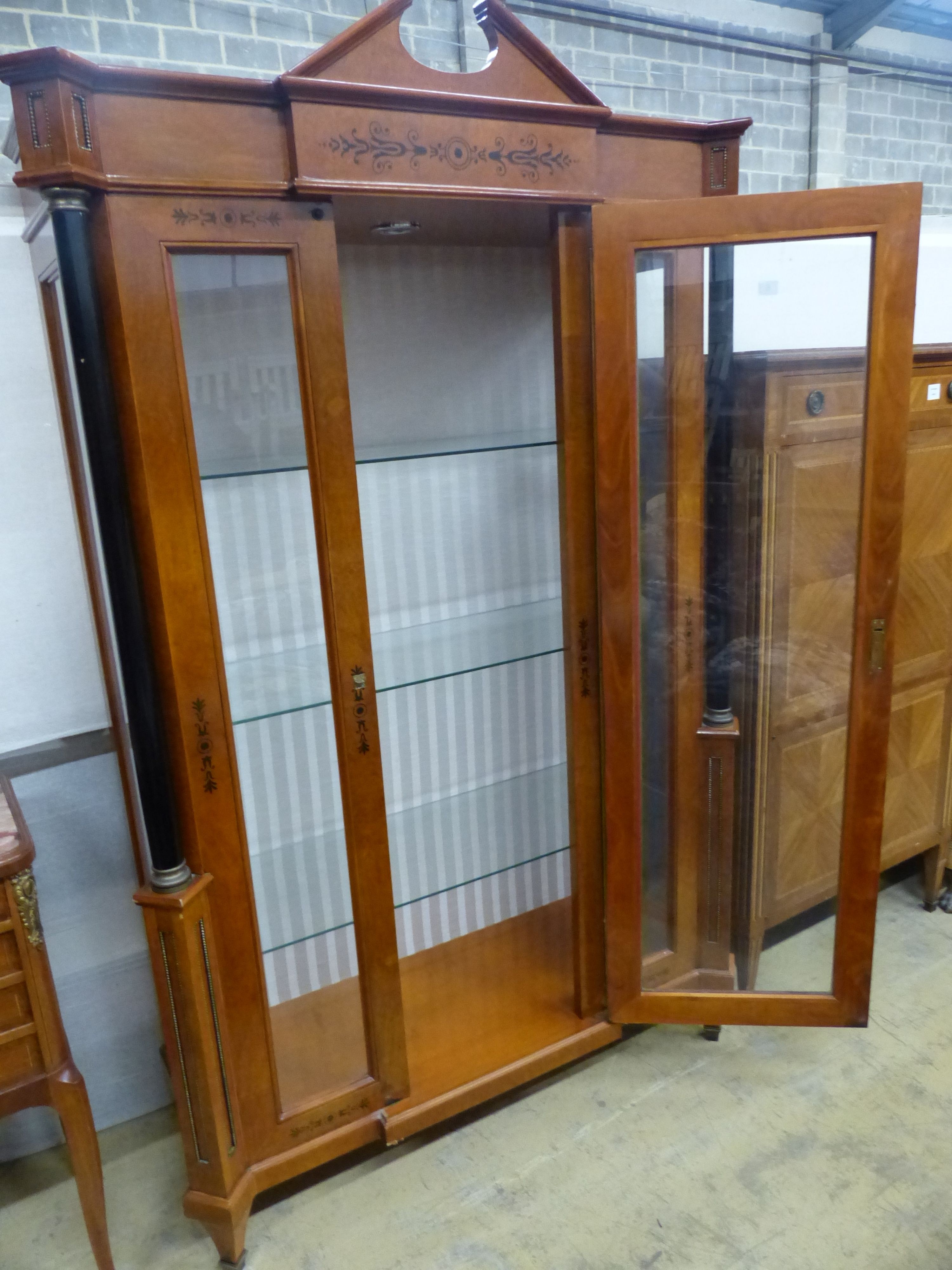 A Biedermeier style ebony inlaid mahogany breakfront display cabinet, W.120cm D.47cm H.197cm